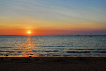 Setting Sun Seen Through Smokey Summer Skies at Fannie Bay Beach In Darwin, Australia