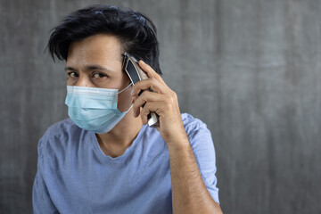 Asian man cuts hair at home during coronavirus quarantine at home