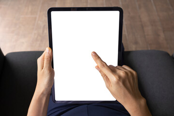 Close-up woman of hand held with digital tablet white screen on sofa in the living room. Concept of...