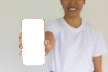 Close-up woman of hand held with smart phone white screen on sofa in the living room. Concept of...