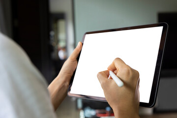 Close-up woman drawing of hand held with digital tablet white screen on sofa in the living room....