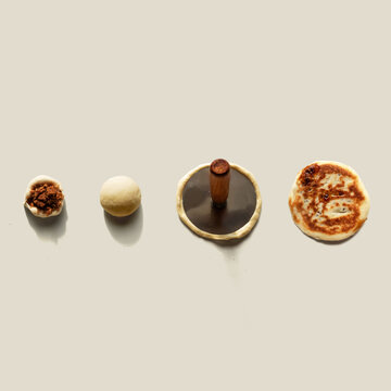 Hotteok on isoloated background. Sometimes called Hoeddeok, is a type of filled Korean pancake. It is a snack from Korean Chinese cuisine and is a popular street food in South Korea.
