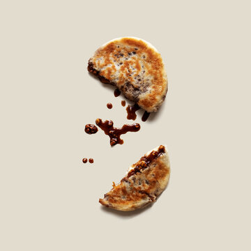 Hotteok on isoloated background. Sometimes called Hoeddeok, is a type of filled Korean pancake. It is a snack from Korean Chinese cuisine and is a popular street food in South Korea.