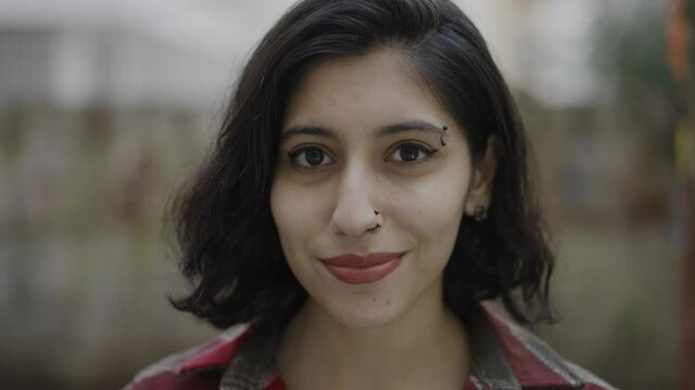Close-up portrait of nice-looking  multi-race brunette beautiful elegant young woman looking into camera. Daily people life, fashion, beauty. Female portraits.