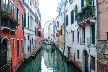 Fototapeta na wymiar Bridge Over Gondola Boat In Canal Amidst Buildings In City