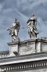 Fototapeta na wymiar Statues on top of Saint Peter Basilica Rome, Italy