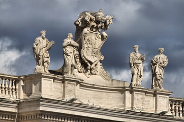 Fototapeta na wymiar Statues on top of Saint Peter Basilica. Rome, Italy