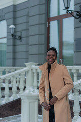 young African American in winter against the backdrop of a majestic building