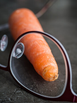 Carrot behind glasses - concept image for healthy sight