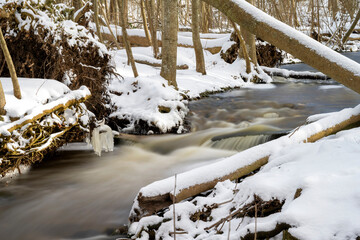 Winter Wonderland: Serene Nature Scene with Flowing Brook and snowy Forest