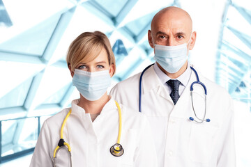 Medical team standing together on the hospital's foyer and wearing face masks