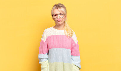 blonde woman looking goofy and funny with a silly cross-eyed expression, joking and fooling around