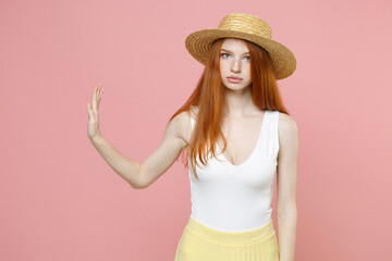 Young serious strict cute refusing caucasian redhead woman 20s ginger long hair wearing straw hat...