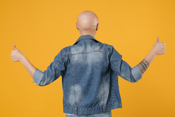 Back rear view of young bald positive satisfied woman 20s without hair wearing stylish casual denim...