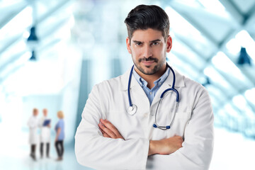 Male doctor portrait while standing on the hospital's foyer