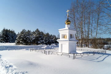 Blanching chapel with gold(en) dome and cross on background wood
