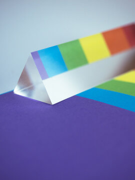 reflecting prism on rainbow colors background