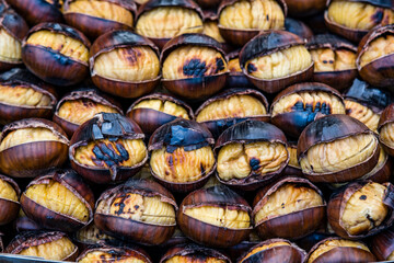 Roasted chestnuts in details while they are preparing them