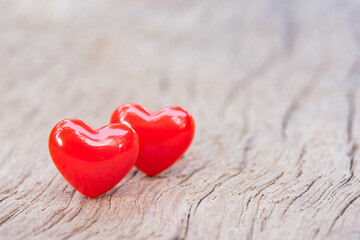 Fototapeta premium Valentines Day background with red hearts on plank wooden, copy space..