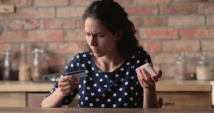 Woman hold cellphone and credit card experiencing financial problem while makes transaction, feels irritated due lack of money, debit card blocking, internet fraud and scam, empty bank account concept