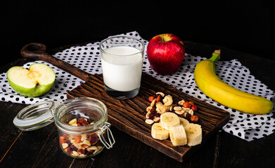 Fresh healthy milk with fruits and nuts. Healthy breakfast ingredients. 