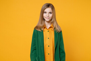 Little blonde pretty cute kid girl 12-13 years old wearing casual clothes green shirt looking camera smiling isolated on yellow orange background children studio portrait. Childhood lifestyle concept