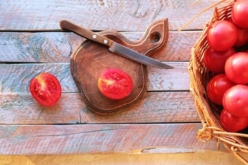 Ripe tomatoes on a cutting board, cooking healthy, natural food, home cooking