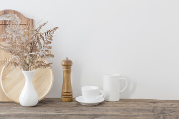 kitchen utensils on  wooden shelf in  white kitchen