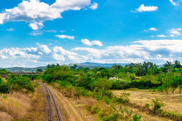 Fototapeta na wymiar Railroad tracks in a tropical climate landscape