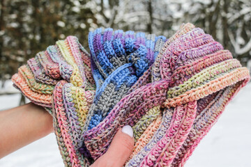 Knitted women's rasta colored headbands in hands