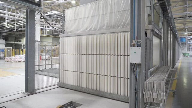Manufacturing of gypsum block or brick, drywall or gypsum board by conveyor on factory. Production of building materials or plasterboard sheet