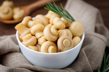 Pickled mushrooms - champignons in a bowl. Food preserving.