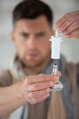 man installing a spotlight on a lamp