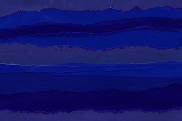 Blue and violet torn paper collage close-up. Texture made from various paper and cardboard parts. Damaged old paper background. Vintage blank wallpaper. Material design backdrop.