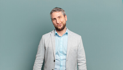 adult businessman looking goofy and funny with a silly cross-eyed expression, joking and fooling...