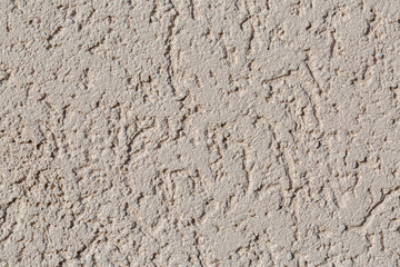 A background of gray sand and cement with curved lines. 