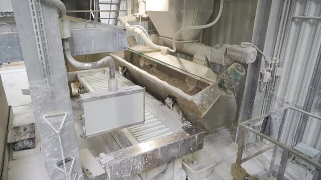 Manufacturing or production of plaster or gypsum mix. Apparatus or machine mixer for kneading or mixing gypsum and water in the factory or plant