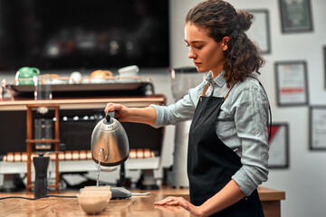 Coffee professional q grader testing and inspecting the quality of arabica coffee beans. offee grounds in a cup on the table. Side view.