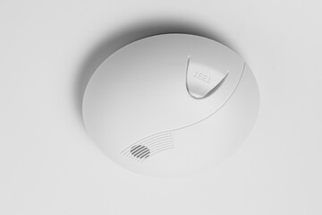 Smoke detector isolated on a white ceiling. Stay home safely