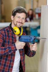 man working using electric drill