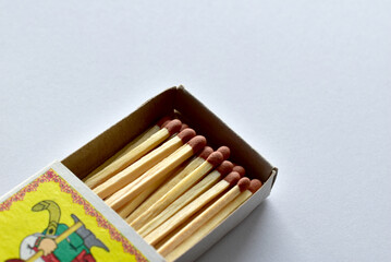 An open matchbox with matches lie on the table.