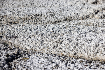 Salt flats texture close up view with water channels running through it