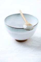 Traditional, handcrafted ceramic on bright wooden background. Soft focus. Close up.