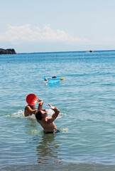 Some young people playing handball in the sea at the beach