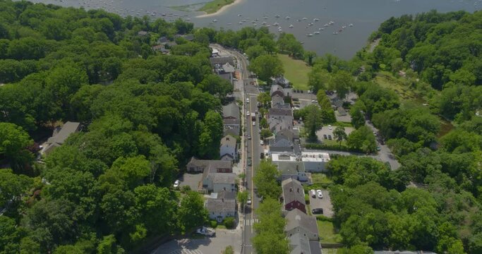 Aerial View of a Small Town Neighborhood and Boats Anchored on Harbor