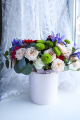 composition of a bouquet of roses and gift box 