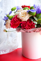 composition of a bouquet of roses and gift box 