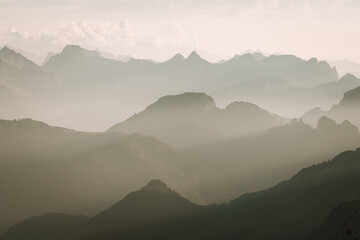 Misty sunset with beautiful silhouette of mountain range in Switzerland