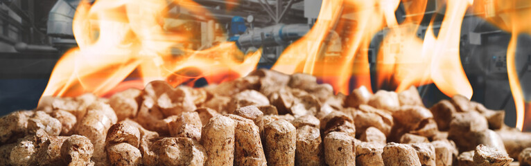 Wood pellets for heating industrial boilers with bio fuel in fire against boilers background....