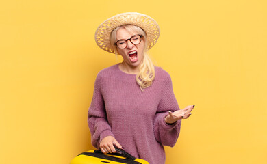 blonde woman looking angry, annoyed and frustrated screaming wtf or what’s wrong with you